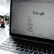 A close-up shot of a laptop displaying a Google search page with related searches visible.