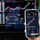 Grafik pergerakan harga saham di layar monitor bursa efek