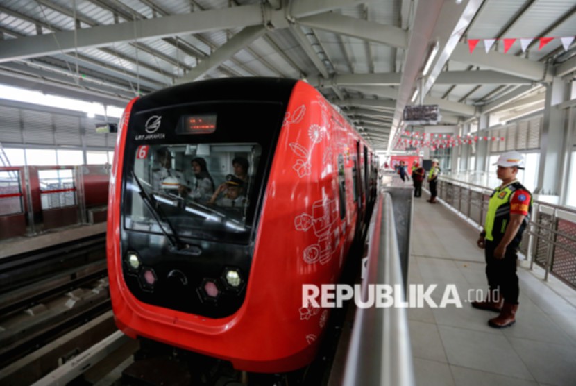 Kereta LRT Jakarta melintas di jalur rel dengan latar belakang gedung perkotaan