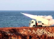 Bendera Amerika Serikat dan Iran berkibar berdampingan di latar belakang yang samar