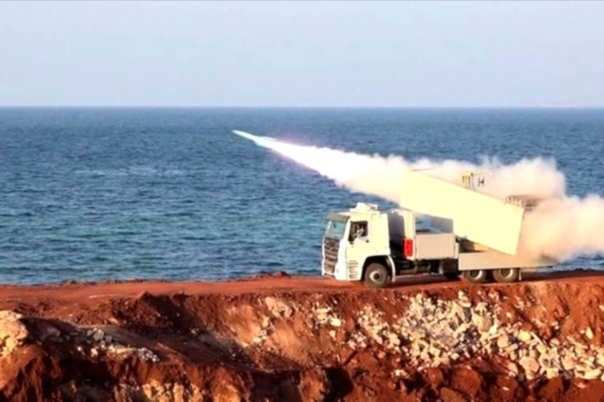 Bendera Amerika Serikat dan Iran berkibar berdampingan di latar belakang yang samar