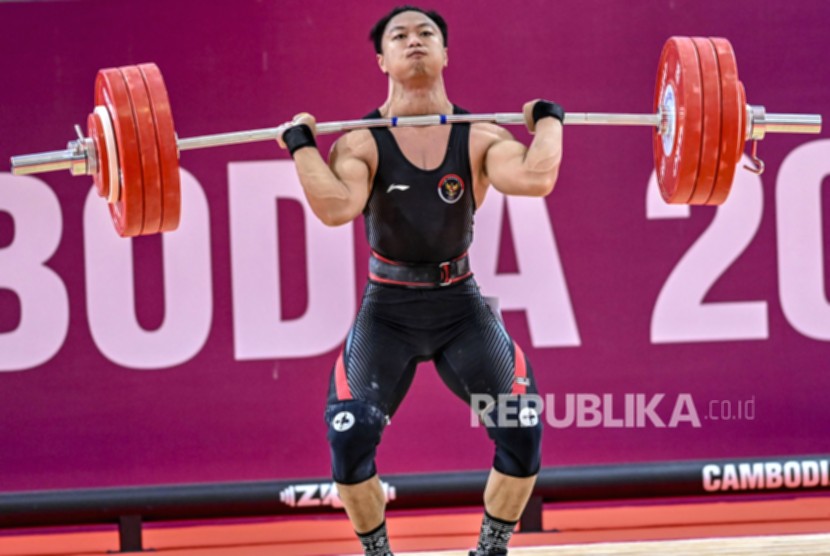 Atlet angkat besi Rahmat Erwin Abdullah merayakan kemenangan setelah meraih medali emas di Asian Games 2026.